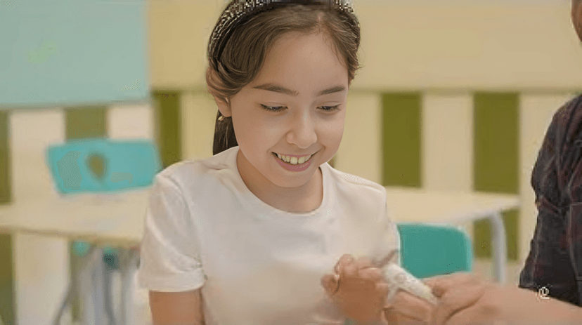 Two children sitting on a board